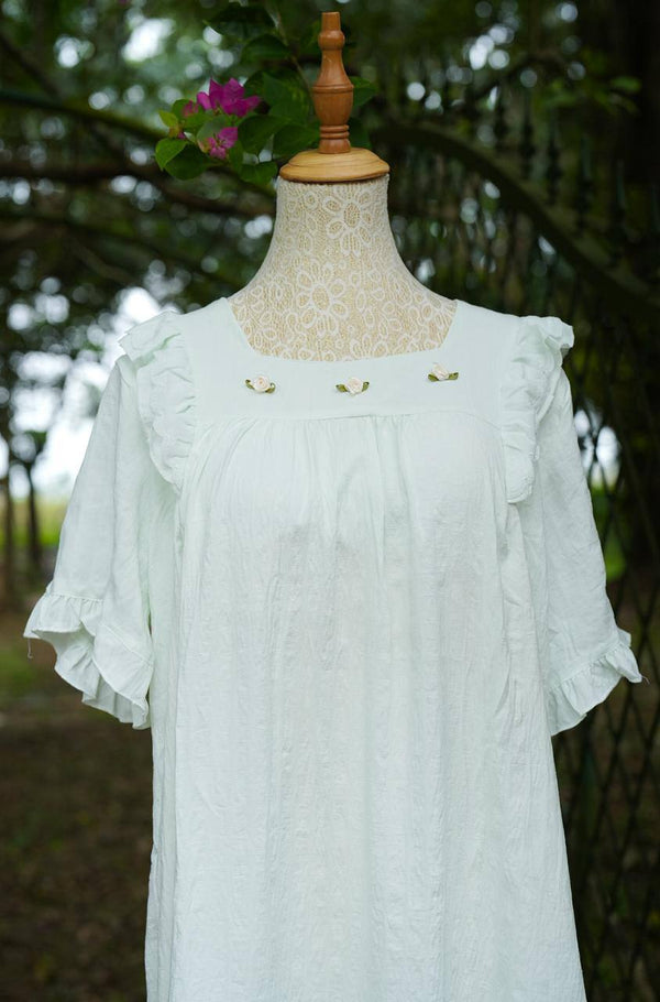 Light blue dress on a mannequin with a blurred natural background